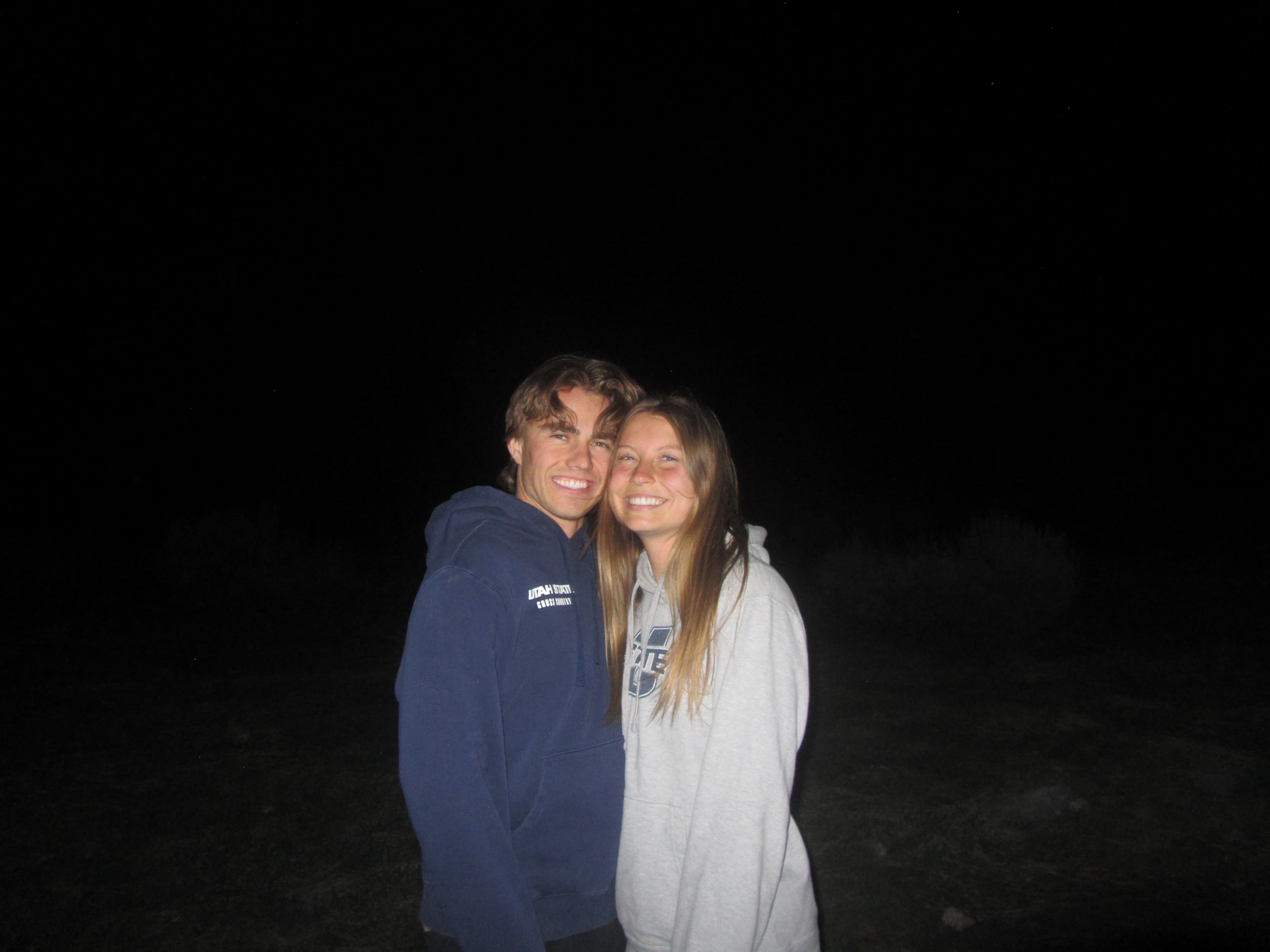 Carson and Courtney smiling together at night, early in their relationship