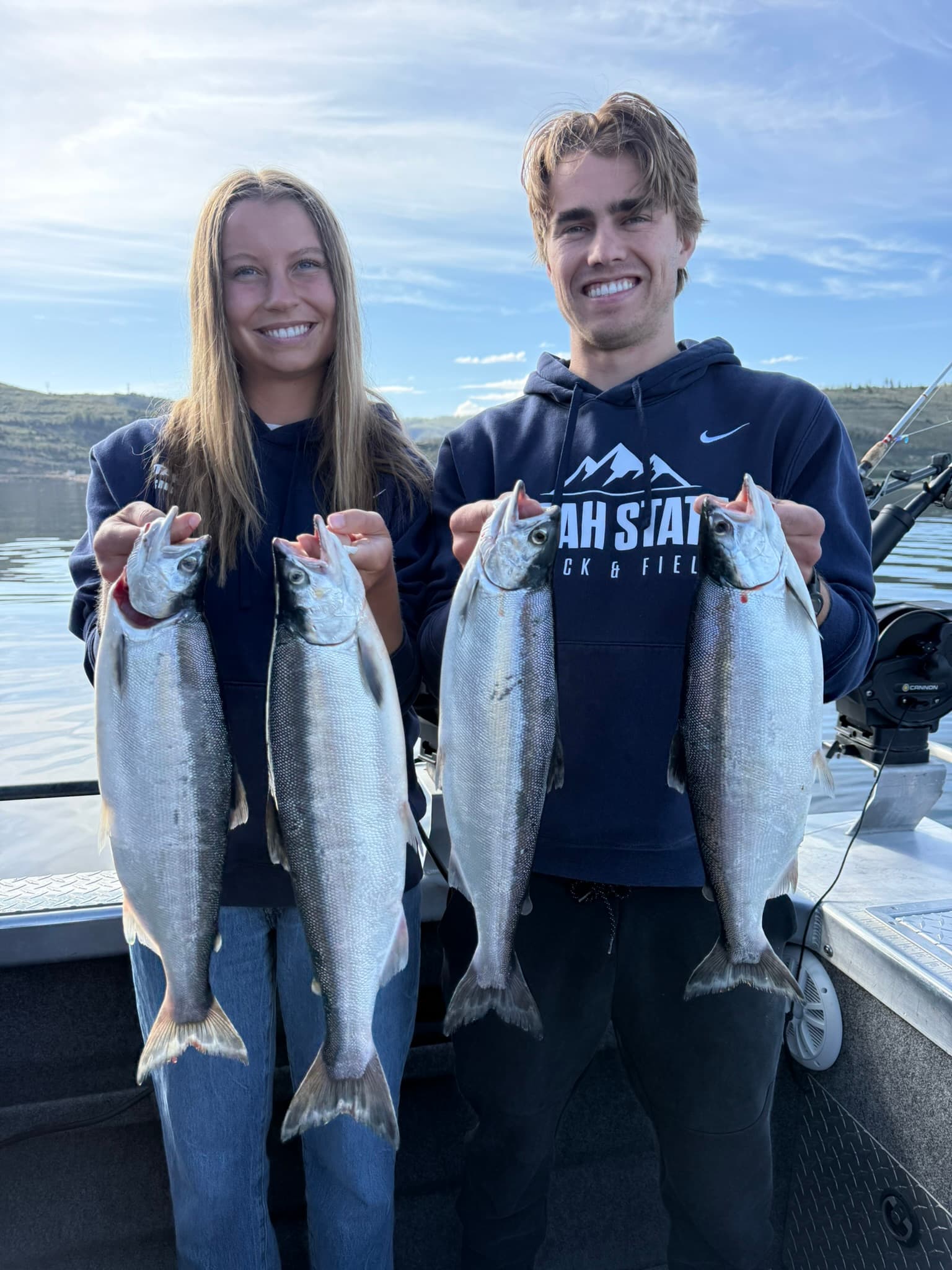 Carson and Courtney holding their catch after a day of fishing